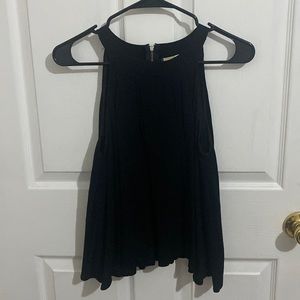 Black shirt, tie neck sleeveless, long in the bottom.